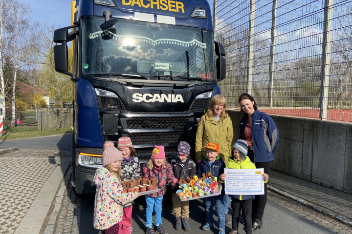Kinder und erzieher vor einem Scania LKW